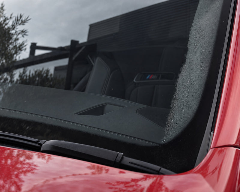 Clear inside windscreen of a red BMW M5 after cleaning, with the last bit of fog by the A-pillar — shown in the article “Car fogging up on the inside: why a clean windscreen stays clear for longer”
