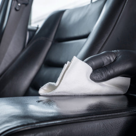 Detailing1 COLOURLOCK Leather Care — spreading the leather care over a black armrest with a cloth